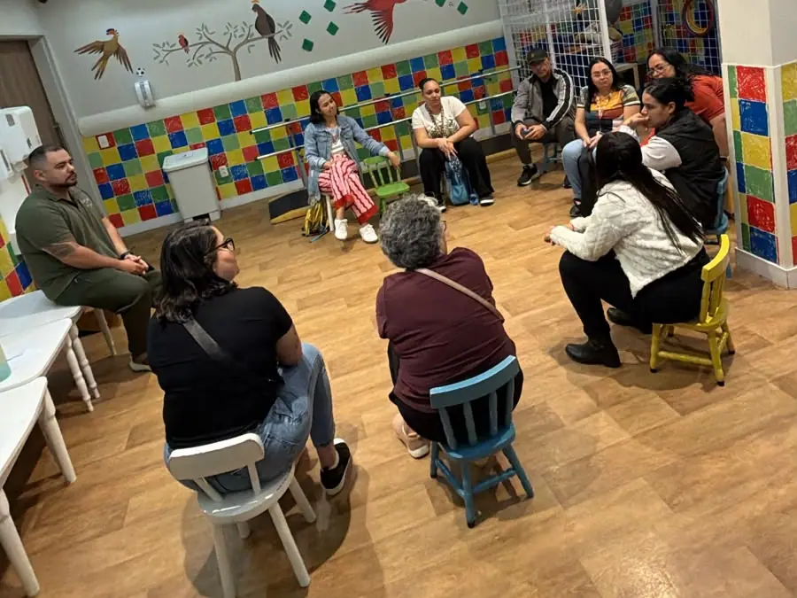 Diego Armando conduzindo um encontro em grupo, com as pessoas sentadas em roda